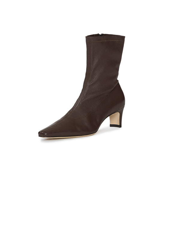 A dark brown leather ankle boot with a pointed toe and a low block heel, shown from a three-quarters angle on a white background.